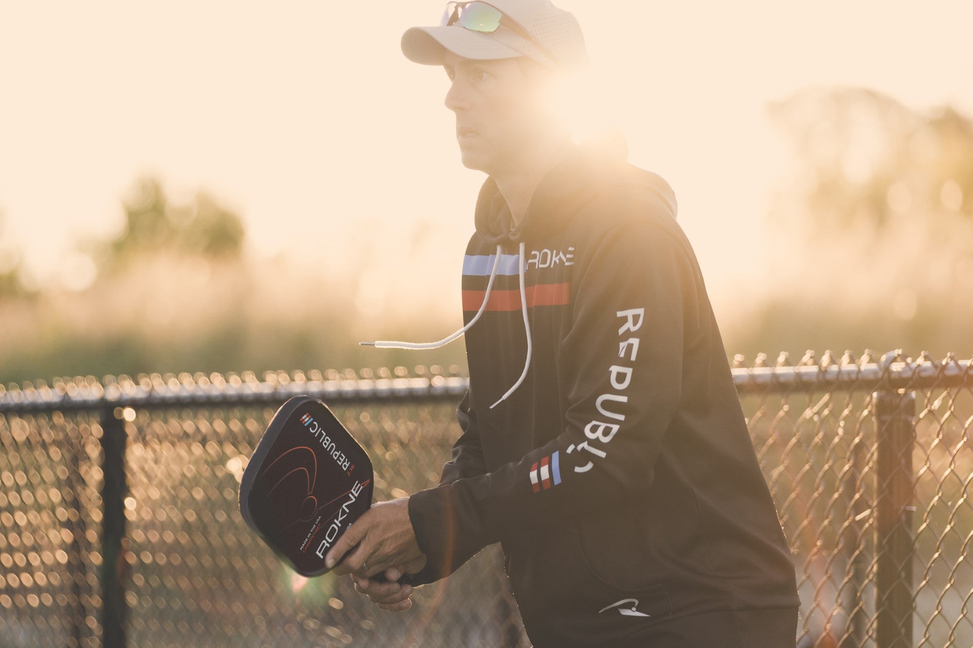 Man playing pickleball with a ROKNE pickleball paddle